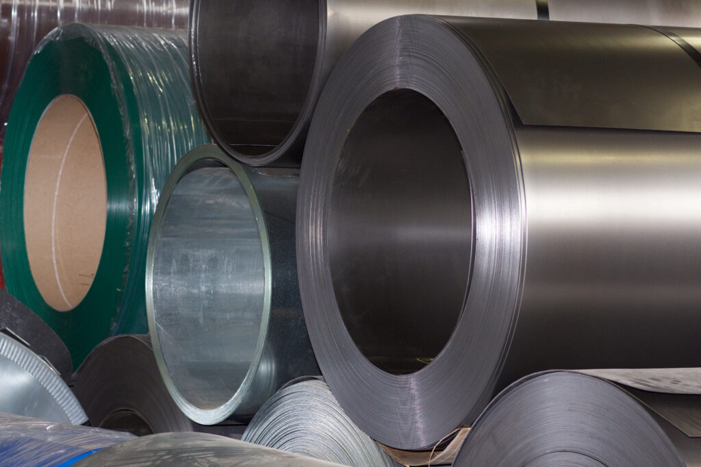 Rolls of galvanized steel coil showing zinc-coated metal surface used in stock tank pool manufacturing.